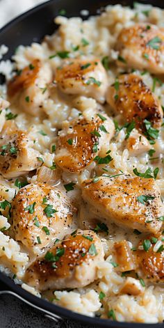 chicken and rice in a skillet with parsley sprinkled on the top