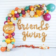 balloons and confetti are arranged in the shape of an arch that reads, friends giving