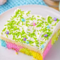 a piece of cake with sprinkles on it sitting on a white plate