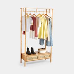 an open wooden rack with clothes and shoes on it