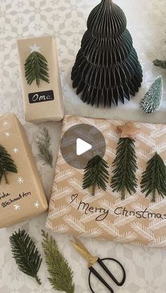 paper christmas trees and other holiday decorations on a table with scissors, ornament