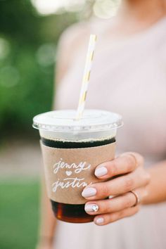 a woman holding a cup with a straw in it