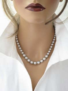 This simple Swarovski pale grey necklace features graduated pearls ranging in size from 6mm up to 10mm. Measures 17 inches in length + a 2 inch extender chain. Items arrive in a beautiful hand decorated gift box. Ready to ship in 3-5 business days. To view the coordinating earrings: https://www.etsy.com/listing/535510209/pearl-earring-swarovski-pale-gray?ref=shop_home_active_5 Elegant Gray Necklace For Wedding, Gray Pearl Necklace For Formal Occasions, Gray Pearl Necklace For Gift, Gray Pearl Pendant Jewelry Gift, Elegant Gray Round Pearl Necklace, Elegant Gray Pearl Necklace, Formal Gray Pearl Necklace, Gray Round Pearl Jewelry, Pearl Necklace Simple