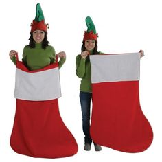 two women wearing christmas stockings and hats holding up a large red and white stocking