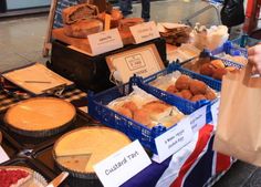 a table filled with lots of different types of pies and pastries on display