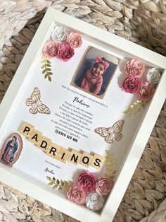 a photo frame with flowers and scrabbles in the shape of letters that spell out padronos