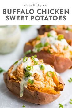 buffalo chicken sweet potatoes on a white plate with green onions and sour cream drizzled over the top