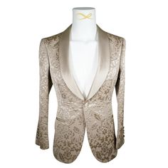 Champagne Oro Designer Fiore Fabric Woven In France Satin Signature Shawl Lapel Single Button Closure Soft, natural shoulder construction Chest Barchetta Pocket Dual Vents Satin covered buttons Handmade in any size! Includes a Sebastian Cruz Couture Pocket Square of your choice! All of our jackets are made with 4" extra of fabric to ensure you don't have to send it back to us if its too small or too big. You can tailor your jacket 2 sizes bigger and/or smaller if needed. We guarantee your satisf Gold Fitted Luxury Blazer, Elegant Gold Outerwear With Suit Collar, Elegant Tuxedo With Lapel Collar And Button Closure, Elegant Tailored Blazer For Gala, Tailored Elegant Blazer For Gala, Luxury Beige Blazer For Semi-formal Events, Luxury Gold Blazer With Lapel Collar, Elegant Beige Party Blazer, Luxury Beige Blazer With Button Closure