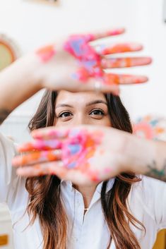 a woman is holding her hands up in the air