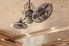 an old fashioned fan hangs from the ceiling