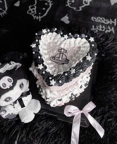 there is a heart shaped cake next to a teddy bear on a black background with white writing