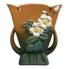 a ceramic vase with flowers painted on it