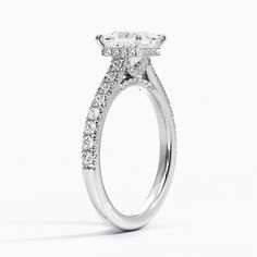 an oval shaped diamond engagement ring with pave set shoulders