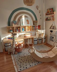 a child's room with a swing chair, bookshelf and toys