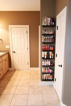 an open door leading to a bathroom with shelves full of condiments