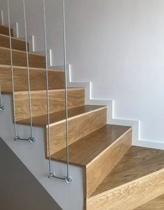 a set of stairs with metal handrails and wood treading on the bottom