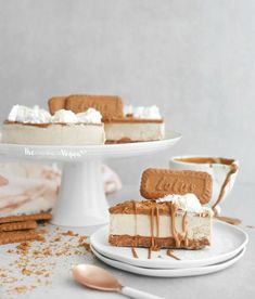 two slices of cheesecake on plates with spoons