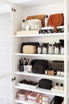 a white closet filled with lots of personal items