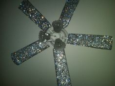 the ceiling fan has glitter on it and is attached to the wall with four blades