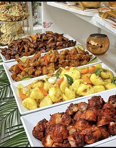 several trays filled with different types of food on top of a table next to each other