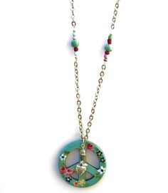 "A large turquoise blue peace sign pendant with colorful painted flowers in pink, yellow, and purple, dangles from a chain that's accented with genuine magnesite beads and little multi-colored wood beads! Sparkling Swarovski crystal rhinestones accent the pretty flowers and add a little glam! Dangling alongside the artful pendant, a little silver heart charm dangles below a genuine turquoise nugget and a rhinestone-encircled bead, adding funky movement! Just choose your sweater chain length to a Bohemian Peace Sign Necklace For Gift, Handmade Hippie Jewelry For Spring, Green Hippie Summer Jewelry, Peace Sign Necklace, Sign Necklace, Sweater Chain, Hand Painted Flowers, Painted Flowers, Genuine Turquoise