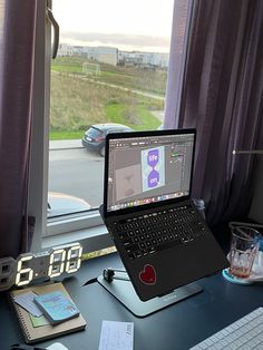 an open laptop computer sitting on top of a desk