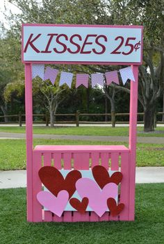 a pink wooden bench with hearts on it