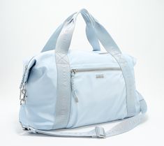 A great grab-and-go bag for weekend getaways, gym days, and so much more, this lightweight duffle boasts plenty of space to stash everything you need, while the double handles, crossbody strap, and built-in luggage strap provides versatile carry options. From Aimee Kestenberg. Sporty Weekend Duffle Bag, Functional Nylon Weekend Duffle Bag, Functional Nylon Duffle Bag For Weekend, Nylon Weekend Travel Bag, Trendy Nylon Gym Bag For Travel, Best Carry On Luggage, Luggage Strap, Dance Bag, Go Bags