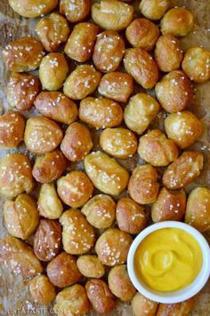 some kind of food that is sitting on a table with sauce in the bowl next to it