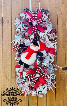 a christmas wreath with a penguin on it