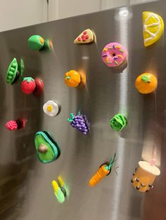 the magnets on the refrigerator are decorated with fruits and vegetables