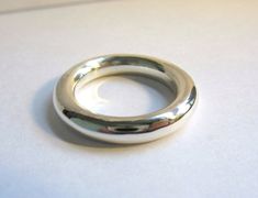 This is a very simple round band. I have been making these for years. As long as people still want this ring, I will continue to make them. They are great to wear in groups of two or even three. They also make great thumb rings.  I make this ring in all metals and any size that you need.  The ring is made of sterling silver. It is 4mm round stock. Minimal Rings Minimalist Jewelry, Minimal Rings, Gold Thumb Rings, Stone Jewelry Necklace, Rings Minimalist, Donut Ring, Chunky Silver Rings, Artisan Rings, Classy Jewelry