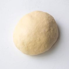 a ball of dough sitting on top of a white table