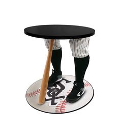 a baseball player with a bat on top of a round table in the shape of a base