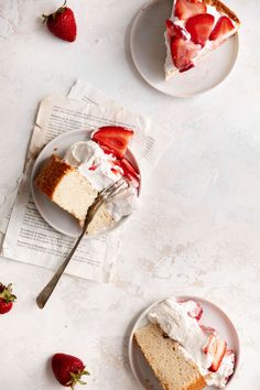 two plates with slices of cake and strawberries