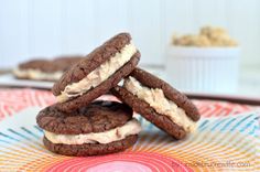 three cookies are stacked on top of each other with white frosting in between them