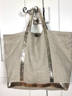 Natural supple linen tote bag with pale gold sequins. Large handheld tote bag with cotton lining, inside zipper pocket and magnetic clasp. Size L: 53x35x19cm  Handles 40 cm Can be worn on shoulder with summer dress. Gold Tote Beach Bag For Summer, Gold Tote Beach Bag For Vacation, Gold Canvas Bag For Everyday Use, Gold Beach Bag For Summer Travel, Gold Travel Bag For Summer, Gold Rectangular Beach Bag For Summer, Chic Summer Canvas Tote Bag, Gold Tote Shoulder Bag For Vacation, Gold Bag For Vacation