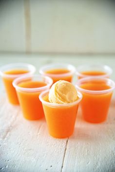 small cups filled with ice cream sitting on top of a table