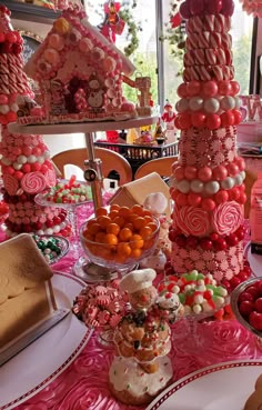 a table topped with lots of candy and candies on top of plates covered in icing