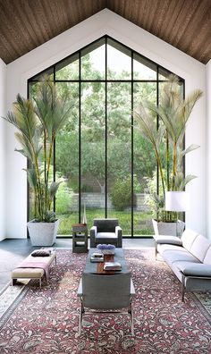 a living room filled with furniture and large windows