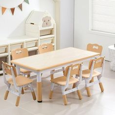 a child's table and chairs in a white room