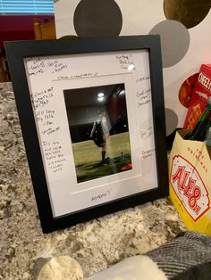 a baseball player signed autographed in a framed photo next to a bag of chips