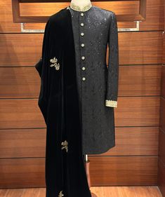 With our stunning Black Embroidered Sherwani for men, you can exude sophistication while combining classic style and contemporary appeal. The entire sherwani is covered in an exquisite floral design that is painstakingly embroidered onto the opulent silk fabric. Finished with zardozi embroidery by hand on the collar and cuffs, this piece exudes subtle elegance. The dispersed flower embroidery adds a classic and elegant appearance, resulting in a tasteful blend of traditional and modern design el Elegant Sherwani With Intricate Embroidery In Jamawar, Elegant Jamawar Sherwani With Intricate Embroidery, Elegant Ceremonial Dupatta With Dabka Work, Elegant Dupatta For Ceremonial Occasion With Dabka Work, Elegant Sherwani With Intricate Embroidery, Elegant Traditional Drape Bandhgala For Eid, Elegant Designer Embroidered Sherwani, Elegant Embroidered Sherwani For Designer Wear, Elegant Bandhgala For Eid With Traditional Drape