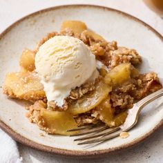 a white plate topped with an apple crisp pie and ice cream on top of it