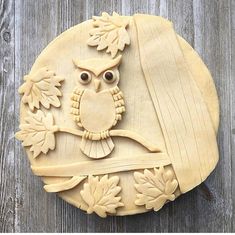 an owl carving on top of a piece of wood