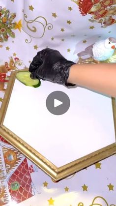 a person in black gloves holding a cucumber on top of a white board