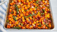 a casserole dish filled with sweet potatoes and vegetables