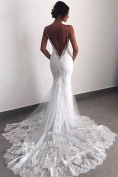 a woman in a white wedding dress looking back