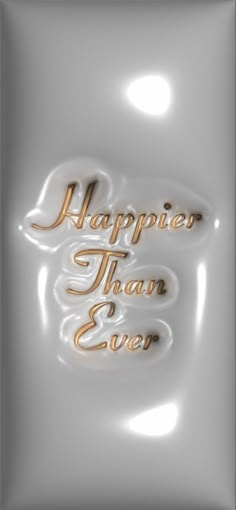 the words happy than ever are written in gold on a white background with shiny foil