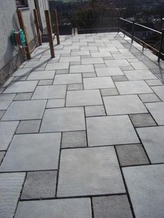 an outdoor patio with stone tiles on the ground